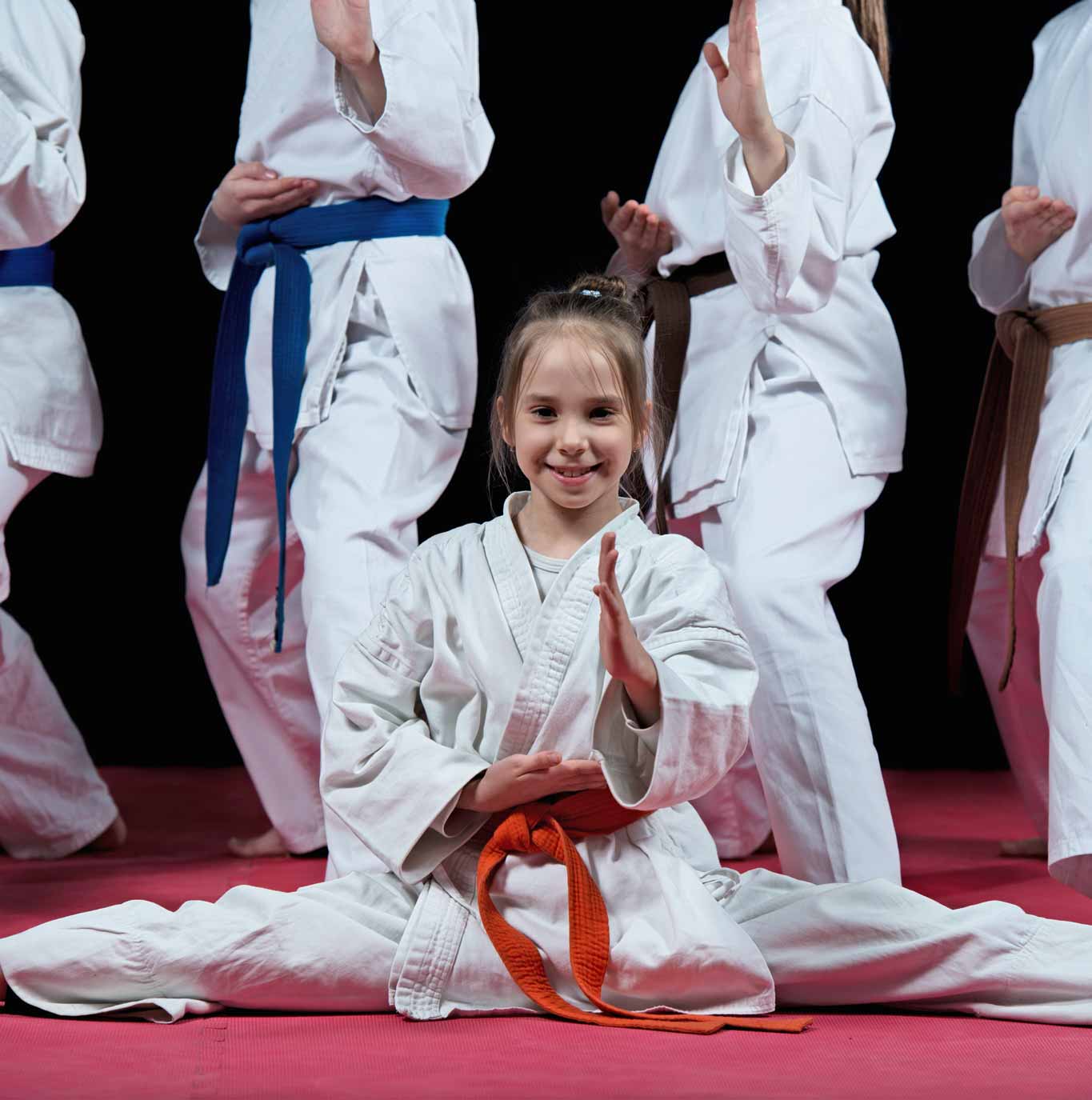 A young girl doing the splits in training